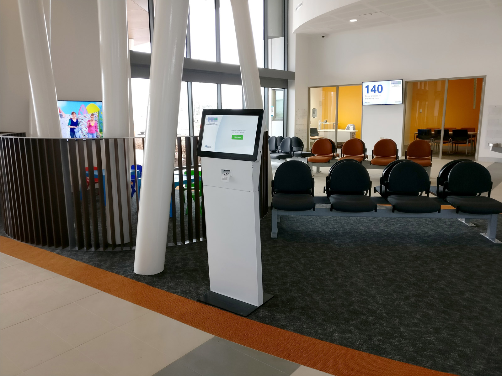 The visitor kiosk was deliberately left unbranded to better blend into the décor. Visitors collect their ticket and are directed to the waiting area. Photo courtesy Pro AV Solutions
