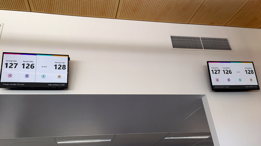 The waiting area displays show the status at all four service desks at once, so visitors who were looking away when their number was called still know where to go. Photo courtesy Fredon Technology.
